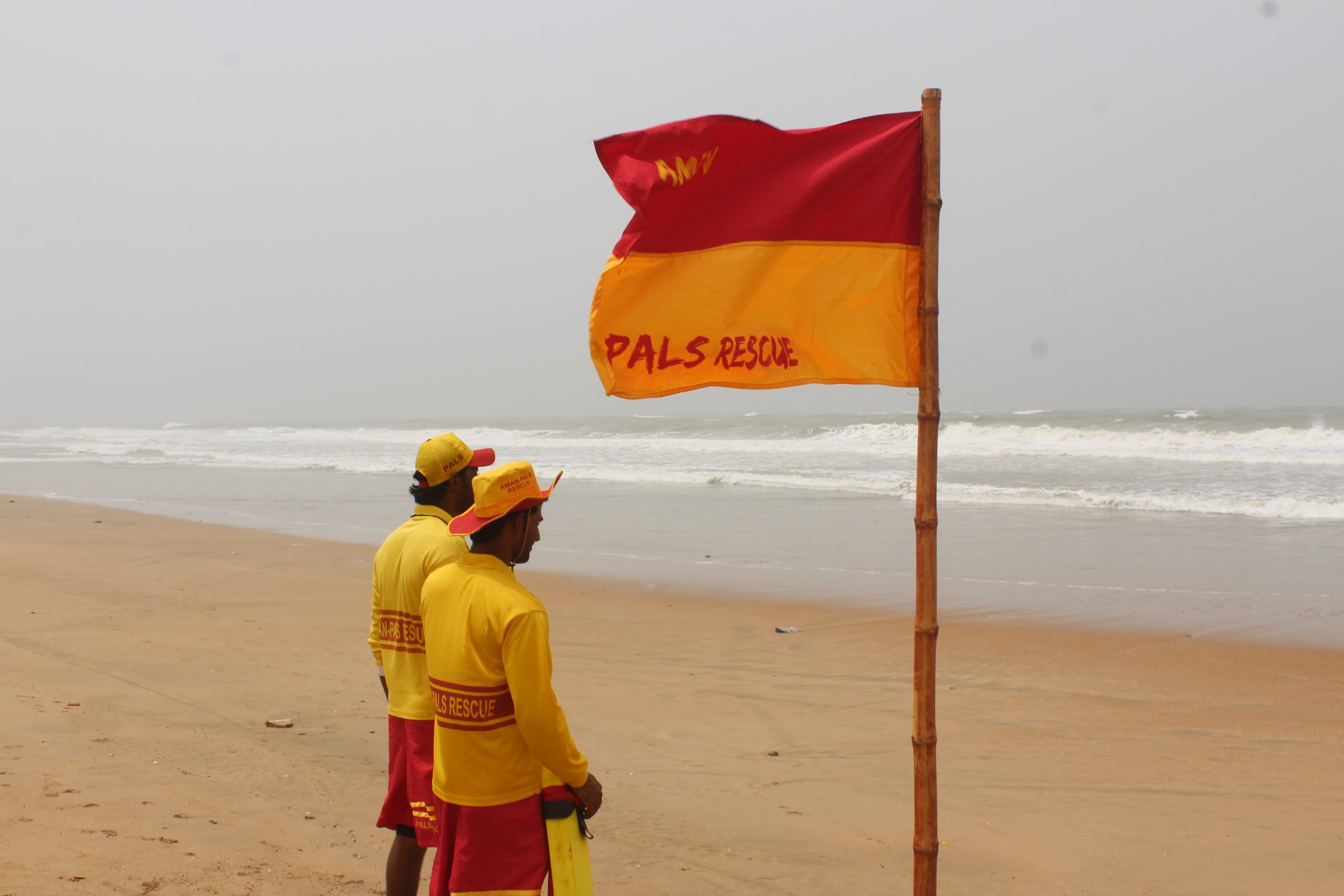 "Lifeguards from PALS Rescue supervising a corporate beach event in Karachi with watersports activities in the background."